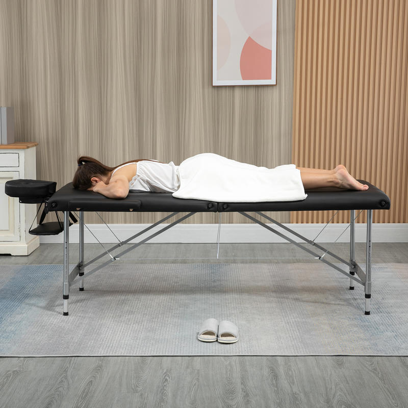 Portable Massage Table Featuring a Face Hole, Arm Supports, Hand Rests, And Dimensions of 186 Cm X 71 Cm X 83 Cm.